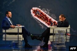 Italy’s Interior Minister and Deputy Prime Minister Matteo Salvini (L) speaks with Italian journalist Bruno Vespa, on the TV set of talk show "Porta a Porta", broadcasted on Italian channel Rai 1, in Rome, June 20, 2018.