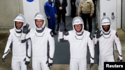 NASA astronauts Stephen Bowen and Warren ‘Woody’ Hoburg, the United Arab Emirates’ Sultan Al-Neyadi and Russian cosmonaut Andrey Fedyaev gesture ahead of NASA’s planned SpaceX Crew-6 mission launch from the Kennedy Space Center in Cape Canaveral, Florida, Feb. 26, 2023. The launch was then postponed.