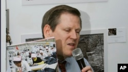 Phil Robertson, deputy director of Human Rights Watch's Asia division, speaks while showing its report titled "Work Faster or Get Out" Labor Rights Abuses in Cambodia’s Garment Industry during a press conference in Phnom Penh, Cambodia.