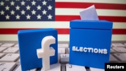 FILE PHOTO: A 3D-printed elections box and Facebook logo are placed on a keyboard in front of U.S. flag in this illustration taken Oct. 6, 2020. 