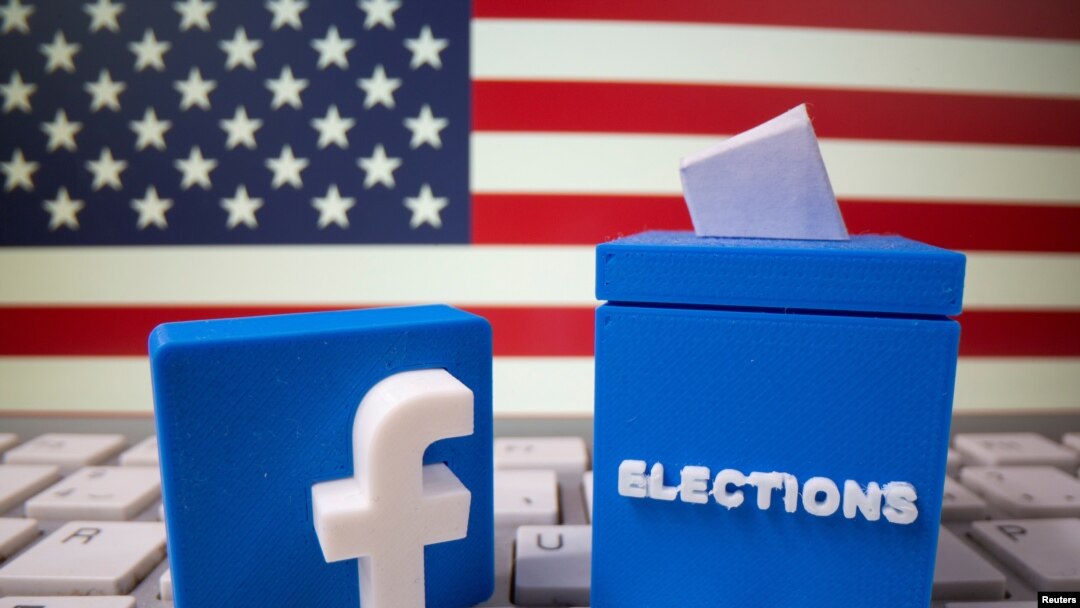 FILE PHOTO: A 3D-printed elections box and Facebook logo are placed on a keyboard in front of U.S. flag in this illustration taken Oct. 6, 2020. 