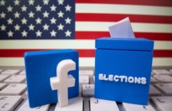 A 3D-printed elections box and Facebook logo are placed on a keyboard in front of U.S. flag in this illustration taken Oct. 6, 2020.