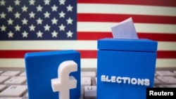 FILE PHOTO: A 3D-printed elections box and Facebook logo are placed on a keyboard in front of U.S. flag in this illustration taken Oct. 6, 2020. 