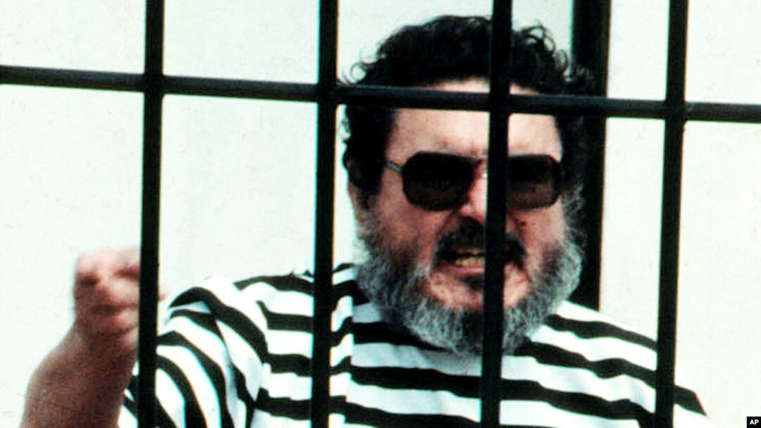 FILE - Abimael Guzman, the founder and leader of the Shining Path guerrilla movement, shouts inside of a jail cell after being captured in Lima, Peru, in this September 1992 photo.