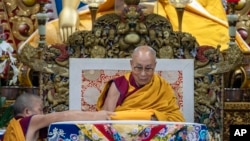 FILE - Tibetan spiritual leader the Dalai Lama sits on his ceremonial chair after he arrived at the Tsuglakhang temple to give a sermon at the request of a Buddhist group from Taiwan in Dharamshala, India, Sept. 30, 2024.