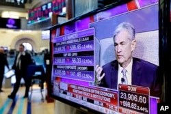 Federal Reserve Chairman Jerome Powell's speech at The Economic Club of Chicago, appears on a screen on the floor of the New York Stock Exchange, April 6, 2018.