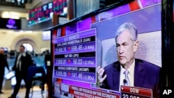 Federal Reserve Chairman Jerome Powell's speech at The Economic Club of Chicago, appears on a screen on the floor of the New York Stock Exchange, April 6, 2018.