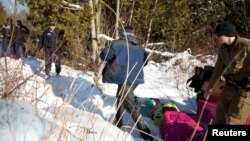 A man who claimed to be from Sudan runs for the border after his family crossed the U.S.-Canada border into Hemmingford, Canada, from Champlain, New York, Feb. 17, 2017.