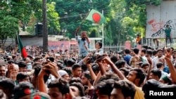 People celebrate the resignation of Prime Minister Sheikh Hasina in Dhaka