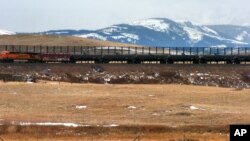 FILE - A train hauls oil into Glacier National Park near the Badger-Two Medicine National Forest in northwest Montana. U.S. Interior Secretary Ryan Zinke appears to be carving out an exception for his home state from the Trump administration’s agenda to open more public lands to natural resources development.