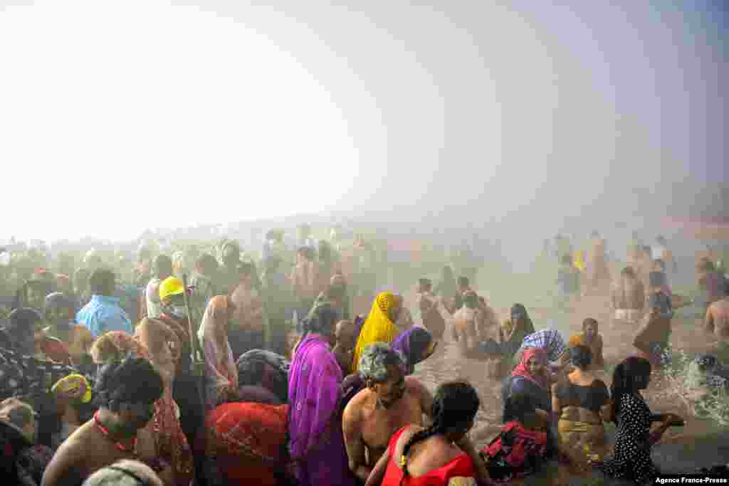 Hindu devotees take a holy dip at the Sangam, the confluence of the rivers Ganges and Yamuna and mythical Saraswati, on the auspicious bathing day of 'Mauni Amavasya' during the annual Magh Mela festival in Allahabad, India.