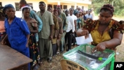 A woman casts her vote in a ballot box n empty ballot box at Agulu in Anambra State on February 6, 2010. Glitches marred voting for a new governor Saturday in Nigeria's turbulent Anambra state, seen as a litmus test of whether Africa's largest democracy c