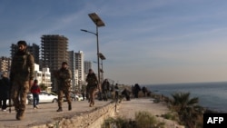 Rebel fighters patrol the coastal Syrian city of Latakia, Dec. 10, 2024. Members of the Alawite minority, an offshoot of Shiite Islam, make up about 10% of Syria’s population of 24 million people and are primarily concentrated in the coastal provinces of Latakia and Tartus.