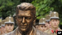 Hungarian military guards of honor stand behind the new statue of late US President Ronald Reagan during a centennial commemoration in Budapest, Hungary, Wednesday, June 29, 2011.