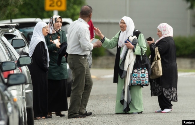 Members of a family react outside the mosque following a shooting at the Al Noor mosque in Christchurch, New Zealand, March 15, 2019.
