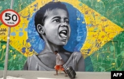 FILE: A man walks past a wall mural depicting a child superimposed on a representation of the Brazilian national flag, in Sao Paulo, Brazil.