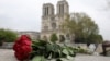 People hug while looking at Notre-Dame-de-Paris in the aftermath of a fire that devastated the cathedral, April 16, 2019. 