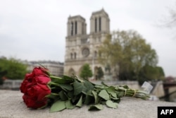 Roses have been laid near Notre Dame Cathedral a day after a fire devastated the cathedral in central Paris, April 16, 2019.