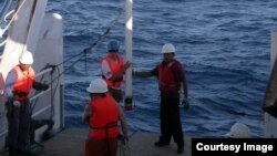 Scientists and sailors on the Indonesian research vessel, the RV Baruna Jaya VIII collect sediment cores off the coast of Indonesia. (Yair Rosenthal, Rutgers University) 