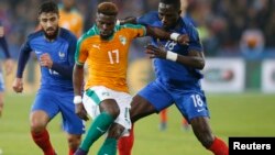 Serge Aurier est en action contre Moussa Sissoko au stade de Lens, en France, le 15 novembre 2016.