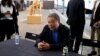 Dissident Chinese artist Ai Weiwei sits at a table at the end of a news conference during a press preview of his new exhibition "Rapture" in Lisbon, Thursday, June 3, 2021.
