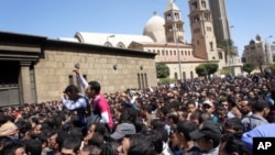 Egyptians converge on Cairo's main Coptic Cathedral to pay their last respects to Pope Shenouda, who died Saturday. Sunday, March18, 2012.