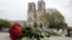 Roses have been laid near Notre Dame Cathedral a day after a fire devastated the cathedral in central Paris, April 16, 2019. 