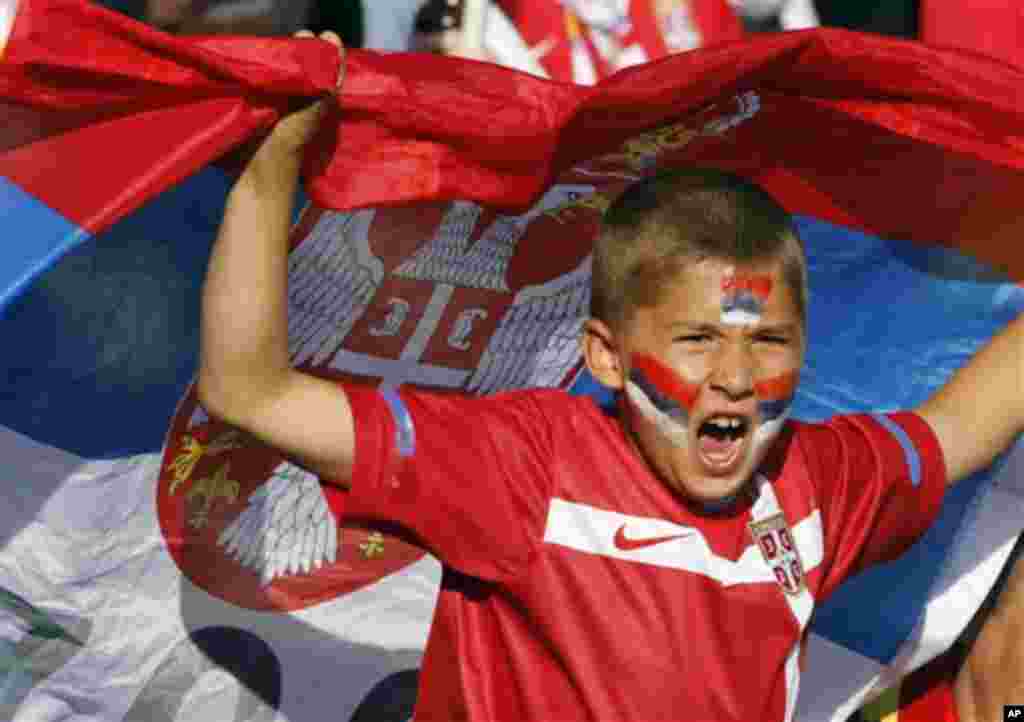 A child cheers with the Serbian flag during the World Cup group D soccer match between Serbia and Ghana at the Loftus Versfeld Stadium in Pretoria, South Africa, Sunday, June 13, 2010. (AP Photo/Darko Vojinovic)