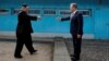 FILE - South Korean President Moon Jae-in and North Korean leader Kim Jong Un, left, are about to shake hands on their first meeting at the truce village of Panmunjom inside the demilitarized zone separating the two Koreas, South Korea, April 27, 2018. 