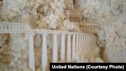 A detail of the ivory model of China's Chengdu-Kunming Railroad shows a train trestle cut into a mountainous landscape. The People's Republic of China presented the sculpture to the United Nations in 1974.