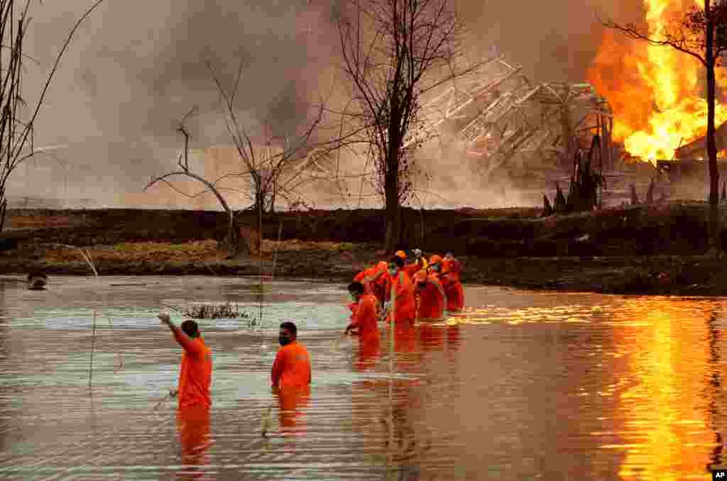 National Disaster Response Force personnel participate in a rescue operation at the site of an oil well that exploded and caught fire in the Baghjan, Tinsukia district in the northeastern Indian state of Assam, India.