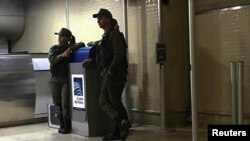 FILE - Venezuelan National Guards stand by a counter of Copa Airlines, at the Simon Bolivar airport in Caracas, Venezuela, April 6, 2018.