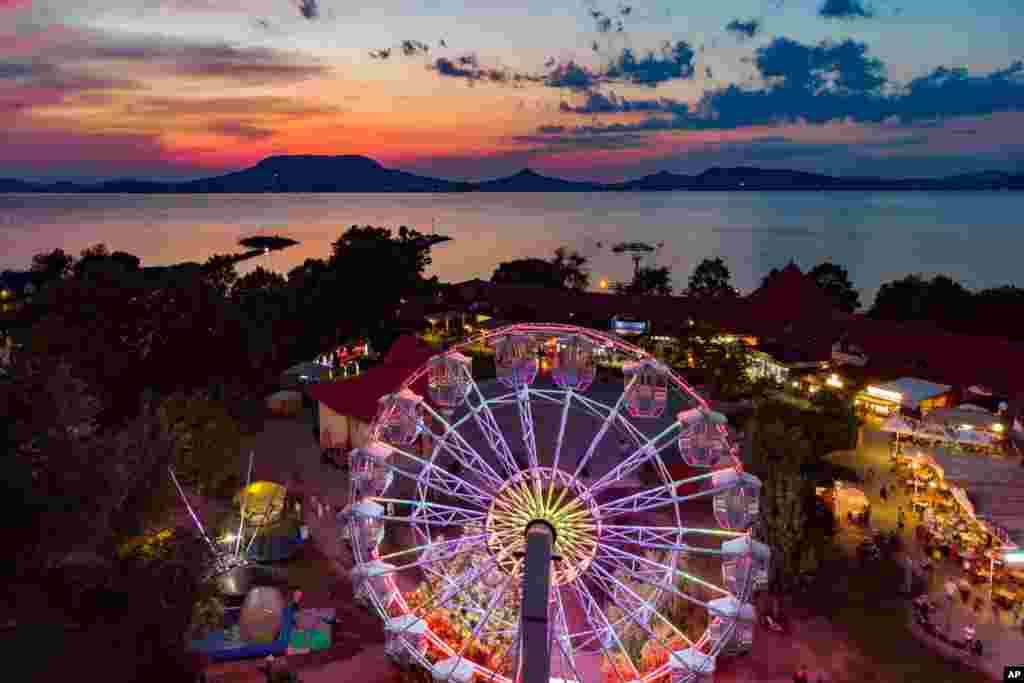 An illuminated Ferris wheel is seen during sunset at Fonyod, Hungary, July 25, 2019. (Gyorgy Varga/MTI)