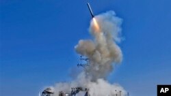 A Tomahawk cruise missile takes off from the USS Barry in 2011 during operations against Libya. The Barry is one of four U.S. Navy destroyers now in position to take part in any U.S. attack on Syria.