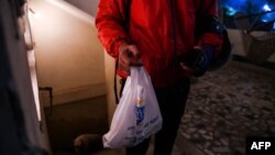 Delivery man Ujjwal Singhal working with the food delivery app Swiggy carries an order to a customer in New Delhi, India, Feb. 6, 2019,. 