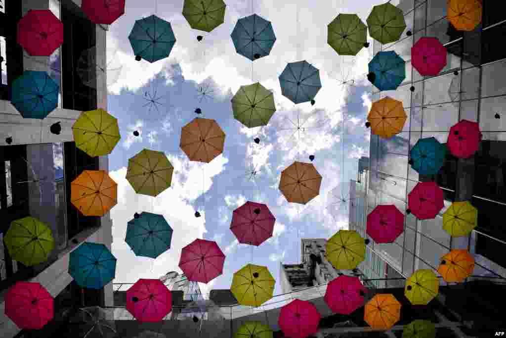 Umbrellas are suspended to mark the first anniversary of the Comix Home Base, an event space for comic illustrators and animators, and venue for workshops and screenings, at the Comix Home Base arts centre in Hong Kong.