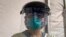 Tuesday, March 31, 2020 photo provided by emergency room nurse Cynthia Riemer shows her at the University of Illinois Hospital in Chicago, wearing a welder’s mask from a hardware store and other hospital-issued protective gear. 