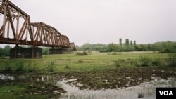 FILE - A former railway bridge spans the Enguri River, the natural border between Georgia and occupied Abkhazia.