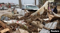 A truck sits among debris in the aftermath of Tropical Storm Lidia in Los Cabos, Mexico, Sept. 1, 2017.