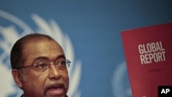 Michel Sidibe, Executive Director of UNAIDS, shows the UNAIDS 2010 Global Report on the global AIDS epidemic at the United Nations in Geneva, Switzerland, Tuesday, Nov 23, 2010