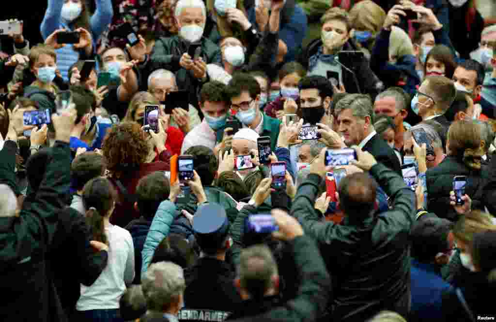 People take pictures of Pope Francis during the weekly general audience at the Vatican, Nov. 3, 2021.