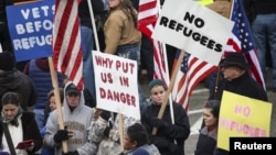 People gather to protest against the United States' acceptance of Syrian refugees at the Washington State capitol in Olympia, Washington, Nov. 20, 2015. Similar lawsuits to that of Indiana's are also pending in Pennsylvania, Texas and Alabama.