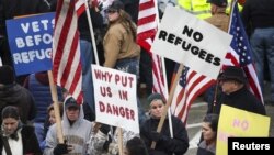 FILE - People gather to protest against the United States' acceptance of Syrian refugees at the Washington State capitol in Olympia, Washington, Nov. 20, 2015. Texas announced Wednesday that it would pull out of the U.S. Office of Refugee Resettlement program.