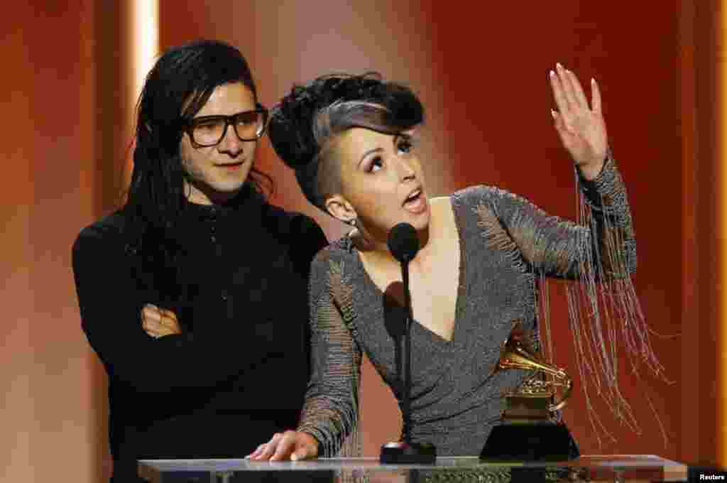 Skrillex and Sirah (R) accept their award for best dance recording for their work "Bangarang" in 55th annual Grammy Awards in Los Angeles, California, February 10, 2013. REUTERS/Mike Blake (UNITED STATES TAGS:ENTERTAINMENT) (GRAMMYS-SHOW) - RTR3DLTO