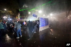 Police usage  a h2o  cannon to forestall  protesters pouring into the streets of Tbilisi Georgia, pursuing  Georgian Prime Minister Irakli Kobakhidze's announcement, Nov. 29, 2024.