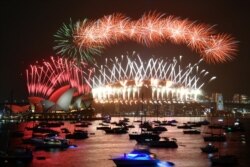 The midnight fireworks are seen during New Year's Eve celebrations in Sydney, Australia.