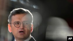 FILE - Ukraine's Foreign Minister Dmytro Kuleba speaks with the media as he arrives for a meeting of EU foreign ministers at the European Council building in Brussels, Aug. 29, 2024.