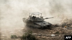 This handout picture released by the Israeli army on May 30, 2024 shows an Israeli army tank during military operations around Jabalia in the northern Gaza Strip, amid the ongoing conflict between Israel and the Palestinian militant group Hamas.