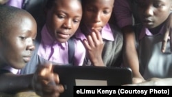 Children in Kenya using eLimu tablet to access educational software.