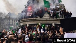 Algerians climbed on the iconic Marianne statue in downtown Paris, France, March 3, 2019.